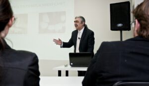 A speaker speaking to an audience.