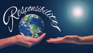 Hand holding a globe, with the word "responsibility" overhead.