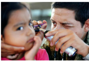 A doctor using an otoscope to look into a child's ear.