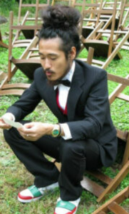 Man sitting outside looking at speech notes.