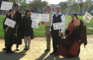 People at a demonstration with signs showing their values.