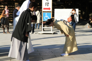 People in traditional Japanese dress, bowing to each other.