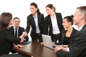 Many people around a table in a business setting.