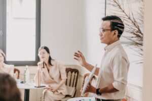 A person speaking to a small group in a conference room.