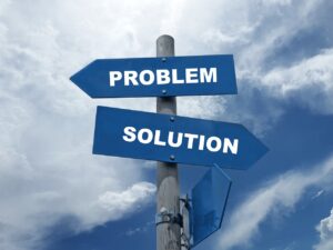 Two road signs pointing different ways, one says "problem" and the other says "solution."