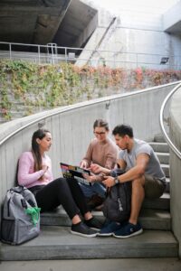 Three college students meeting outside.