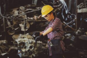 A worker assembling part of a car.