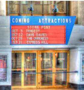 A movie marquee listing coming attractions.