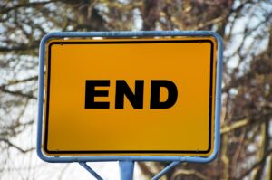 A yellow road sign that says "END."
