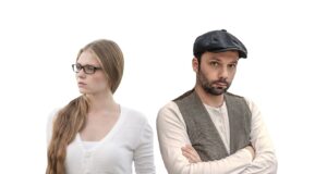 Woman and man facing away from one another, looking upset.